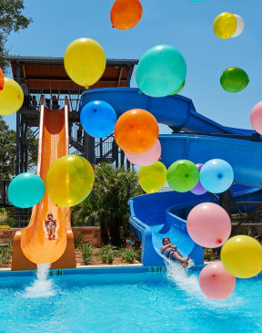 Kids Going Down Water Slides on Sunny Day