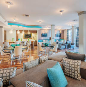 a large living room with couches and chairs at Streets of Greenbrier in Chesapeake, VA 23320