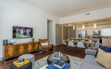 a living room filled with furniture and a flat screen tv