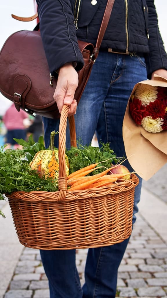Woman Carrying Basket Full of Vegetables