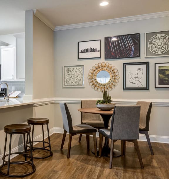 a kitchen and dining room with a counter and chairs