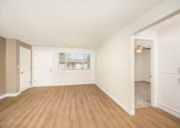 A room with wooden floors and white walls.