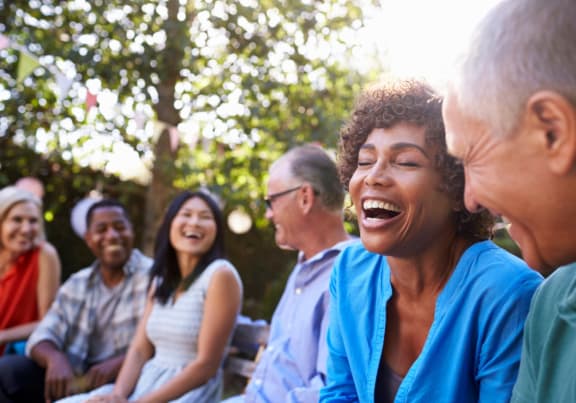 a group of people laughing and talking in a park at Sonder Fields in Happy Valley, OR