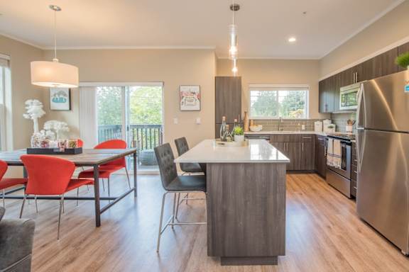 Latitude Apartments and Townhomes in Happy Valley, Oregon Model Kitchen with Island and Dining Area