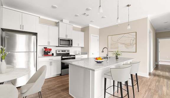 a kitchen with an island and stainless steel appliances