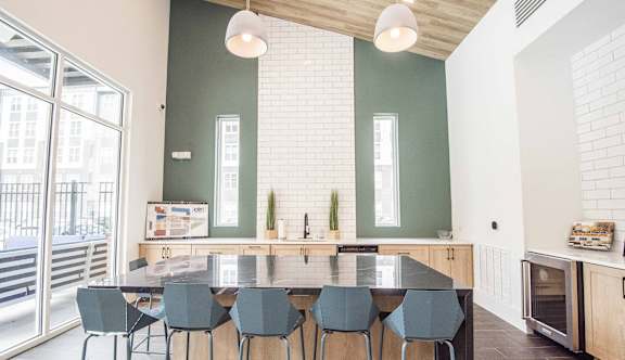 A kitchen with a table and chairs in front of a window.