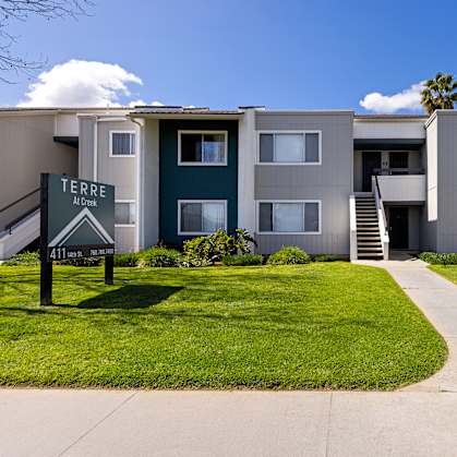 Apartment complex with a sign that says "Terre Apartments".