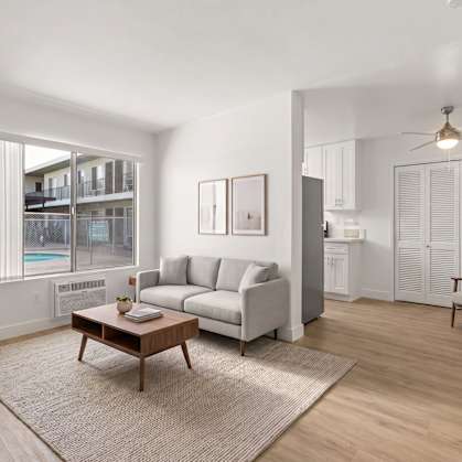 A living room with a couch, a coffee table, and a chair.