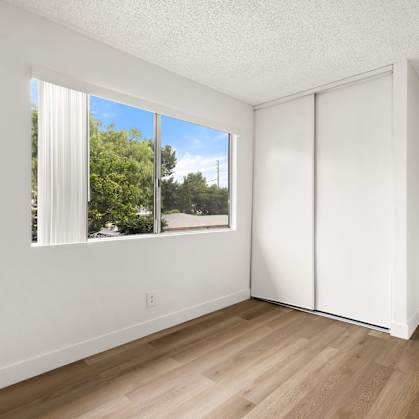 A room with a sliding door and a window.