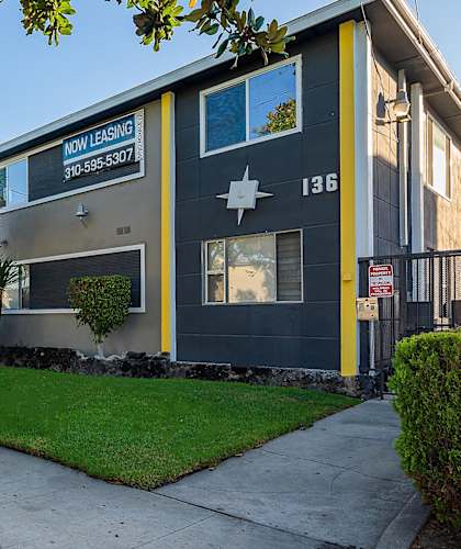 A house with a "Now Leasing" sign on the front.