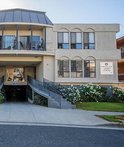 A two-story building with a balcony on the second floor.