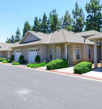 a row of houses with a paved road in front of them