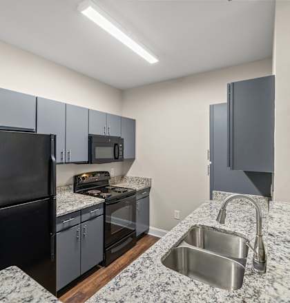 A kitchen with granite countertops and stainless steel appliances.