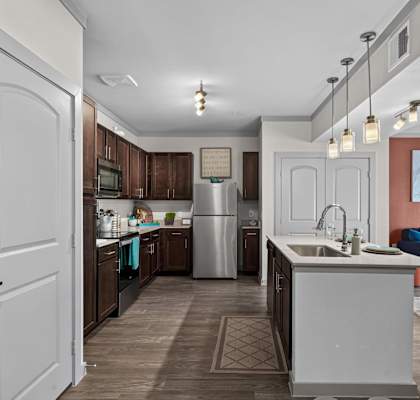A kitchen with a white door and a white sink.