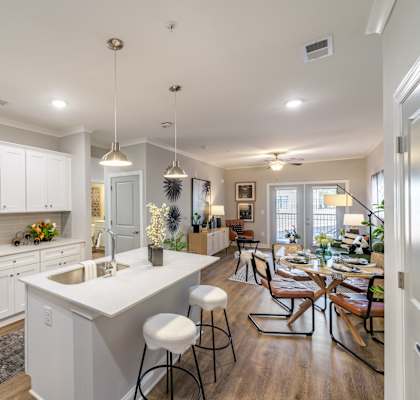 A modern kitchen with white cabinets and stainless steel appliances.