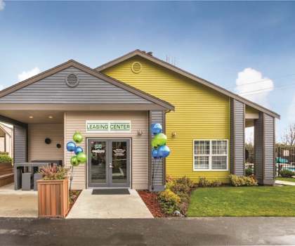 A leasing center is located in a yellow building.