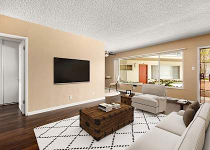 a living room with a white couch and a television