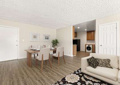 a living room and dining room with a table and chairs