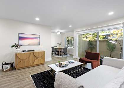 a living room with white walls and a sliding glass door at The Meadows at Westlake Village Apartments, CA, 91361
