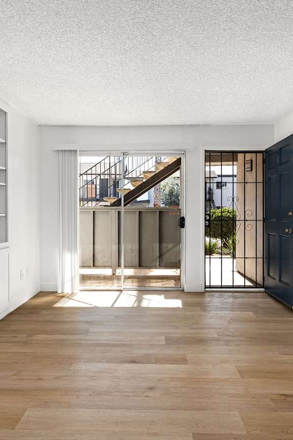 A playground area with a slide, swings, and a sandbox.