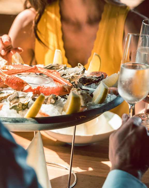 Two women enjoying a meal together at a restaurant at Heritage Bay, Jensen Beach, 34957