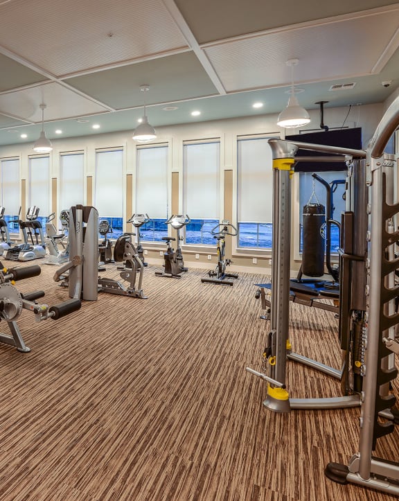 a spacious fitness center with cardio machines and weights at Palm Bay Club, Jacksonville