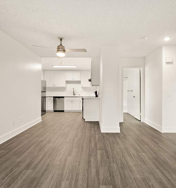 A modern kitchen with a stainless steel refrigerator and a white countertop.
