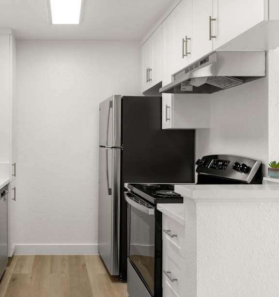 A modern kitchen with a stainless steel refrigerator and a white countertop.