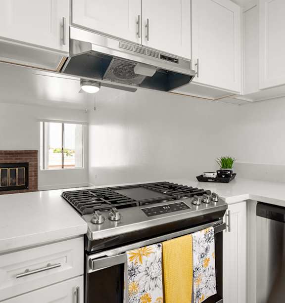 A modern kitchen with a stainless steel refrigerator and a white countertop.