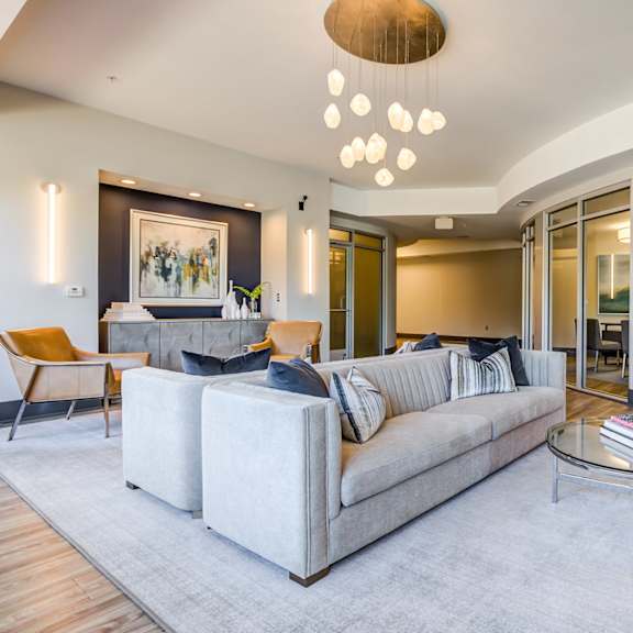 A modern living room with a grey sofa and a coffee table.