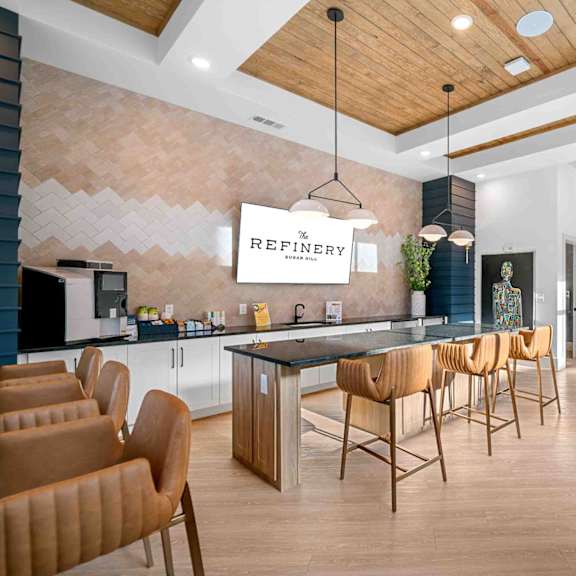 A modern kitchen with a dining table and chairs.