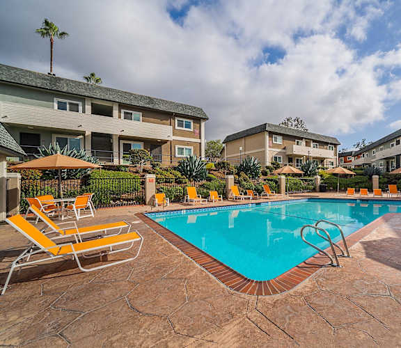 our apartments have a swimming pool with chairs and umbrellas