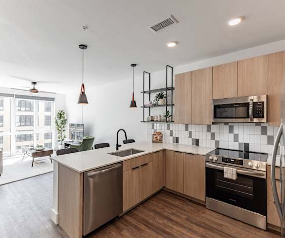 A modern kitchen with wooden cabinets and stainless steel appliances at Anthem House Apartment , Huntsville, Alabama