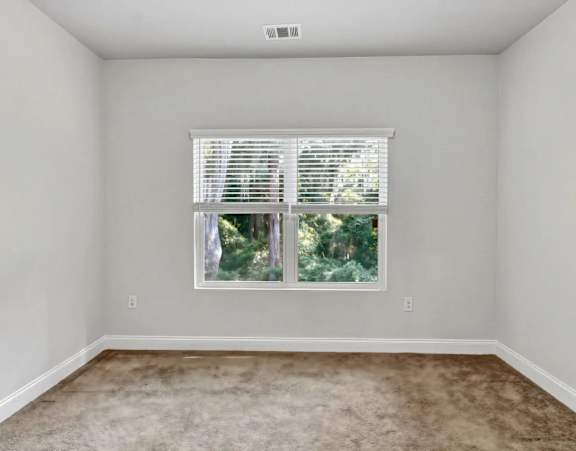 a living room with couches and chairs and a glass coffee table at Uphill Flats, Decatur