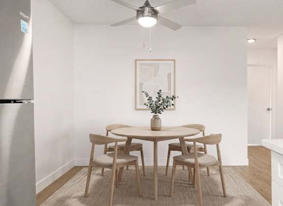 A dining room with a table and chairs.