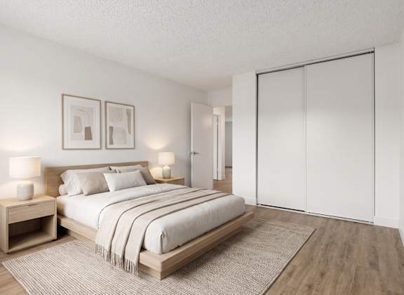 A bedroom with a large bed, two nightstands, and a rug.