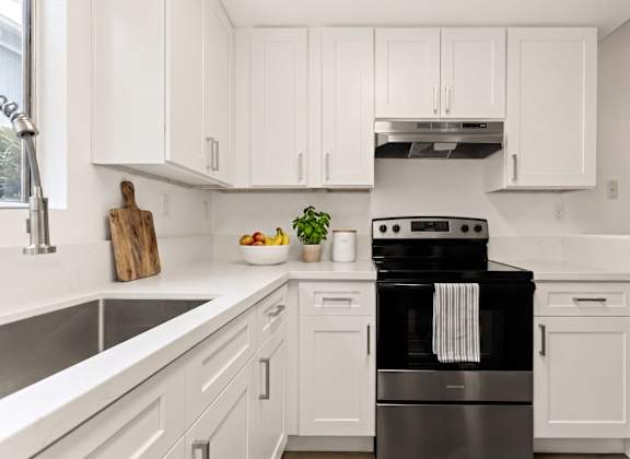 A modern kitchen with a black stove top oven.