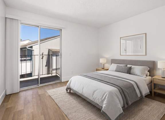 A bedroom with a large bed and a view of the outside.