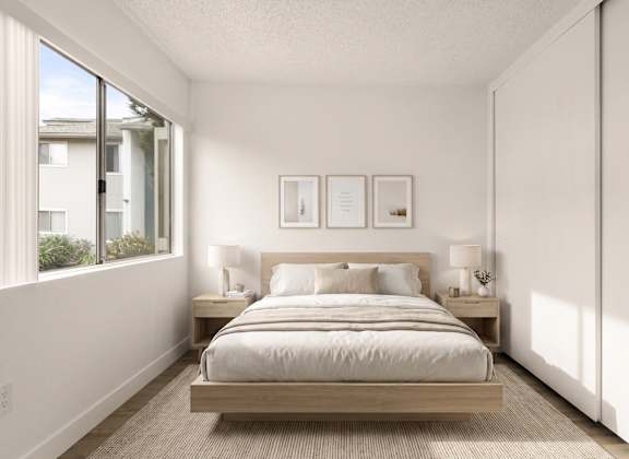 A bedroom with a bed, nightstands, and pictures on the wall.
