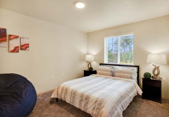 a bedroom with a bed and a window