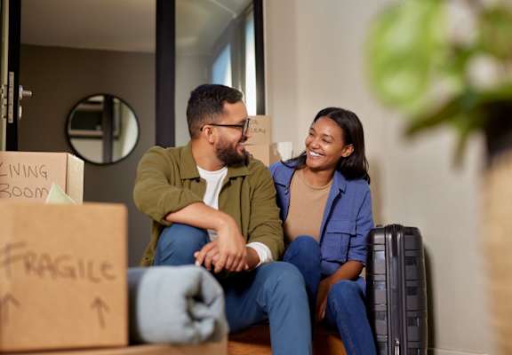 Man and Woman Smiling in Their New Home