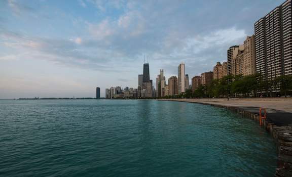 A city skyline is seen from the water.