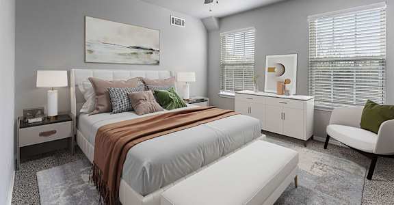 A bedroom with a large bed and a ceiling fan.