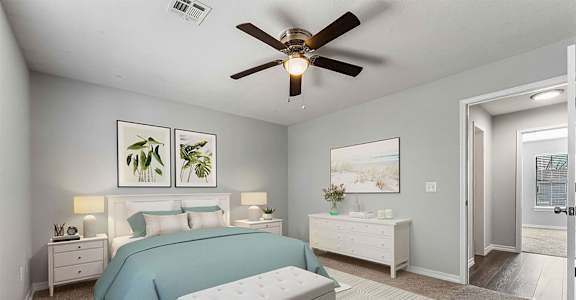 A bedroom with a bed, nightstand, and a ceiling fan.