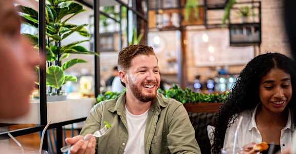 A man and a woman are enjoying a meal together in a restaurant.