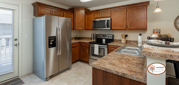 a kitchen with wooden cabinets and stainless steel appliances