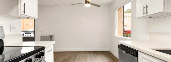 A living room with a white couch and a coffee table.