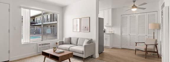 A living room with a white couch and a coffee table.