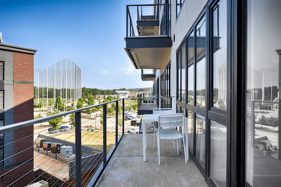 A balcony with a table and chair at Anthem House, Huntsville, 35806