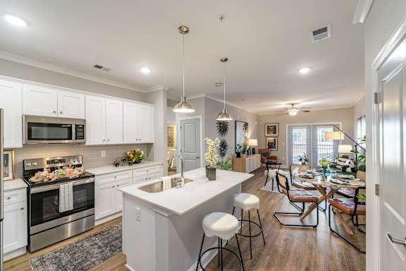 a large kitchen and dining room with a table and chairs